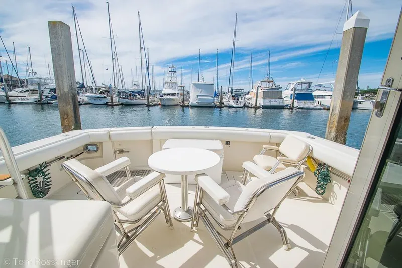 Slide: The Image of 1993 Tiara Yachts 4300 Convertible with seating area, docked in a marina. - 33