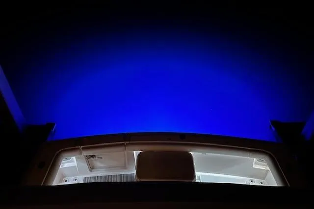 Slide: The Image of 1993 Tiara Yachts 4300 Convertible with illuminated deck against a deep blue night sky. - 35