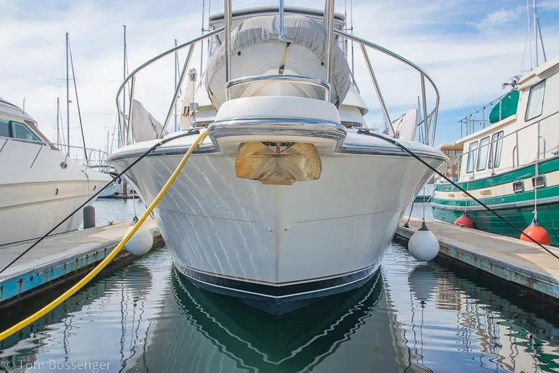 Slide: The Image of 1993 Tiara Yachts 4300 Convertible docked at marina, front view. - 4