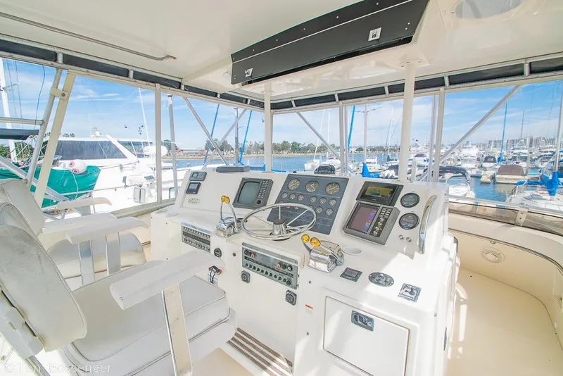 Slide: The Image of Cockpit of 1993 Tiara Yachts 4300 Convertible with marina view. - 40