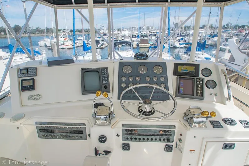 Slide: The Image of Cockpit of 1993 Tiara Yachts 4300 Convertible with navigation instruments and marina view. - 42