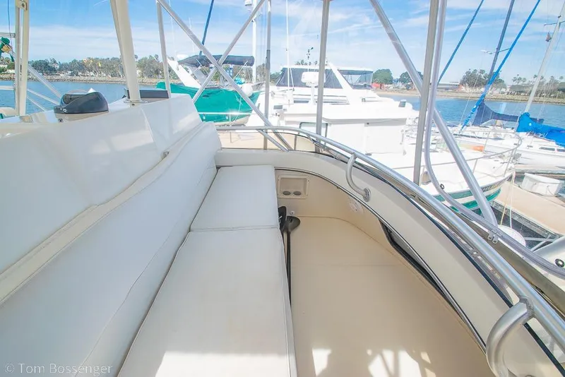 Slide: The Image of Interior view of 1993 Tiara Yachts 4300 Convertible, featuring white seating and marina backdrop. - 47