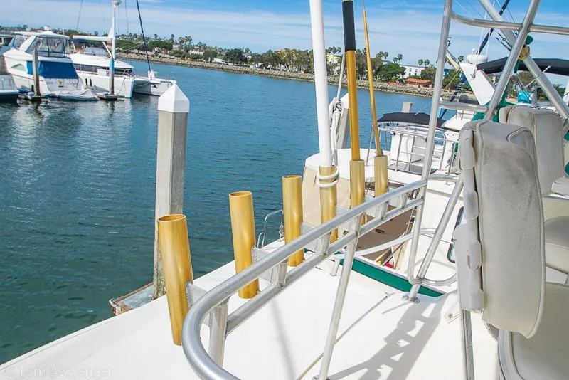 Slide: The Image of 1993 Tiara Yachts 4300 Convertible with fishing rod holders, docked in a marina. - 48
