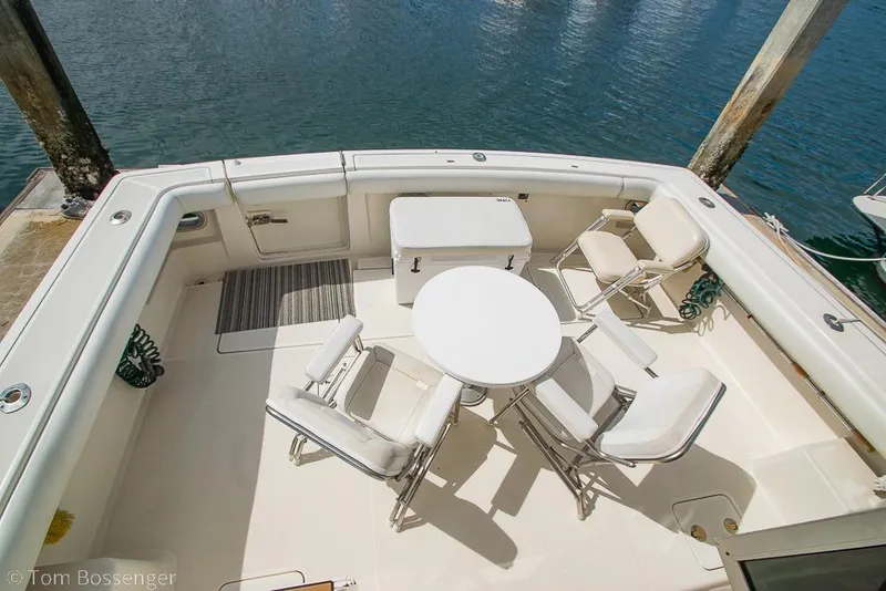Slide: The Image of 1993 Tiara Yachts 4300 Convertible deck with chairs and table by the water. - 49