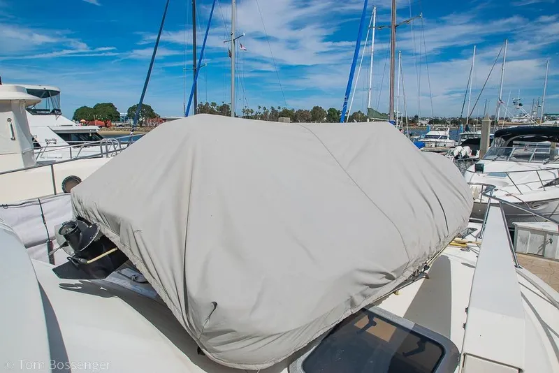 Slide: The Image of 1993 Tiara Yachts 4300 Convertible with covered equipment on deck, docked at marina. - 50