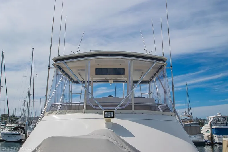 Slide: The Image of 1993 Tiara Yachts 4300 Convertible at marina, clear sky background. - 52