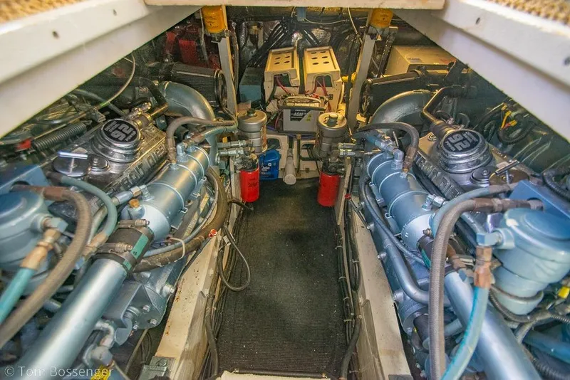 Slide: The Image of Engine room of a 1993 Tiara Yachts 4300 Convertible, showcasing dual engines and mechanical components. - 55