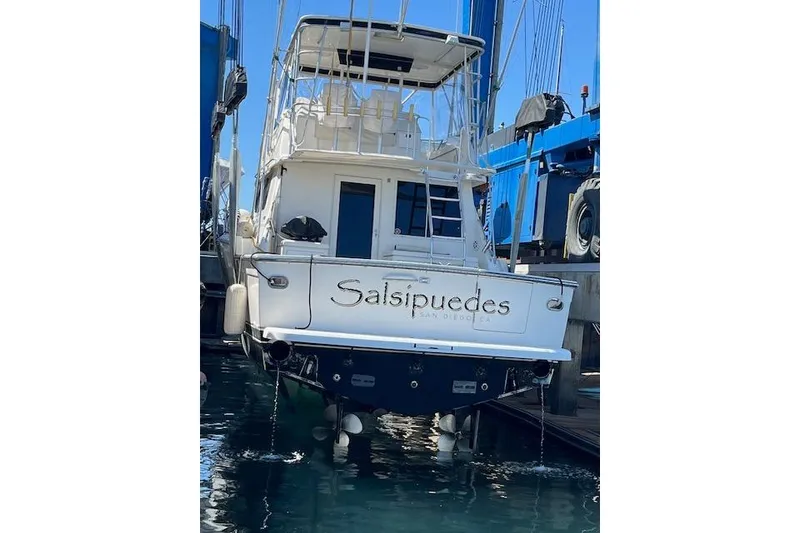 Slide: The Image of 1993 Tiara Yachts 4300 Convertible boat docked, rear view with "Salsipuedes" name visible. - 59