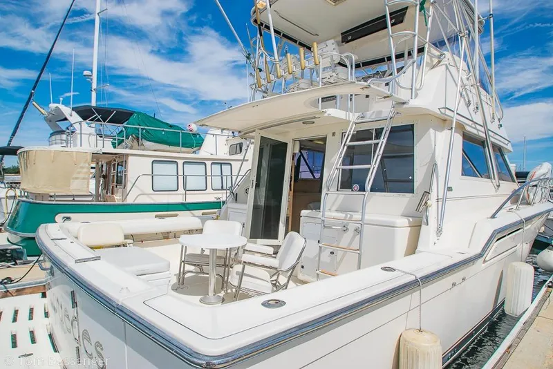 Slide: The Image of 1993 Tiara Yachts 4300 Convertible docked, showcasing spacious deck and sleek design. - 6