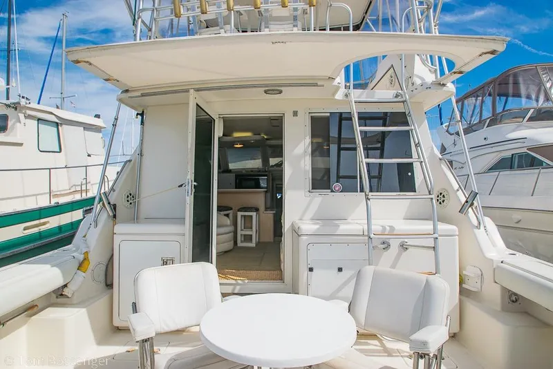 Slide: The Image of 1993 Tiara Yachts 4300 Convertible interior view with seating and table on deck. - 7