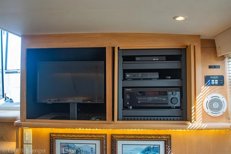 Slide: The Image of Entertainment system inside 1996 Carver 370 Aft Cabin Motor Yacht, featuring TV and audio equipment. - 12