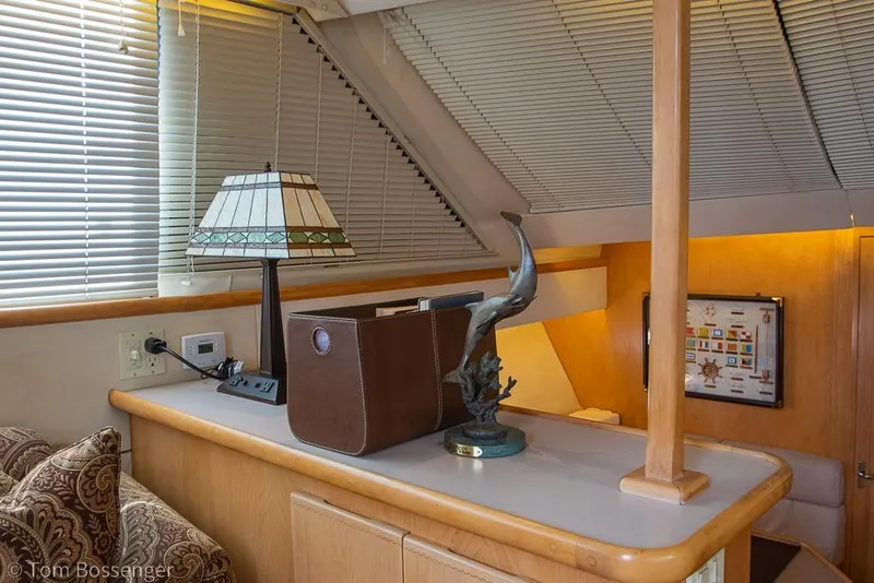 Slide: The Image of Interior of 1996 Carver 370 Aft Cabin Motor Yacht with lamp and dolphin sculpture. - 13