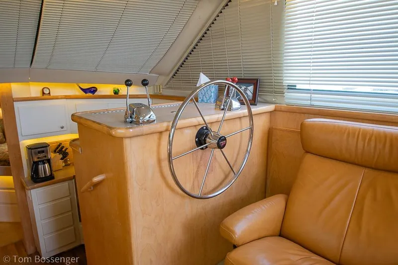 Slide: The Image of Interior of 1996 Carver 370 Aft Cabin Motor Yacht with helm and leather seating. - 14