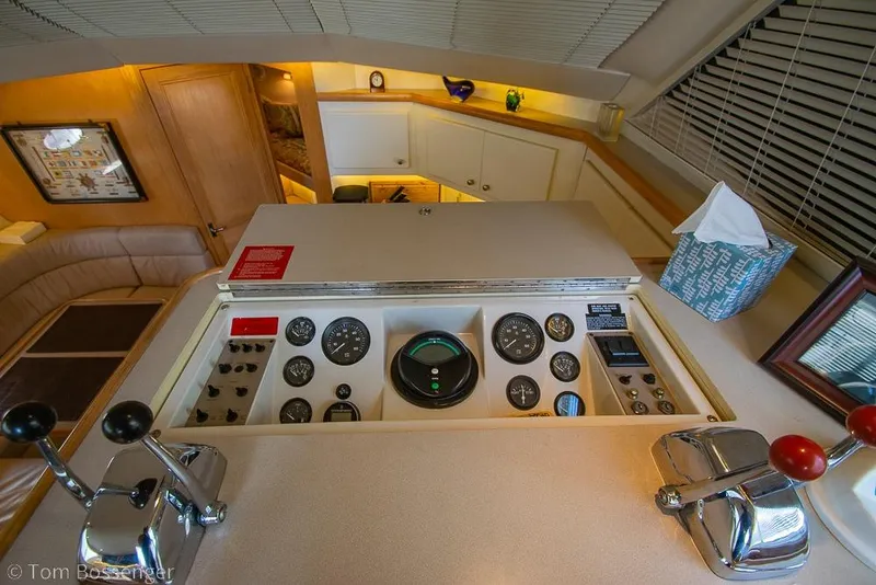 Slide: The Image of 1996 Carver 370 Aft Cabin Motor Yacht helm with gauges and controls in cozy cabin setting. - 15