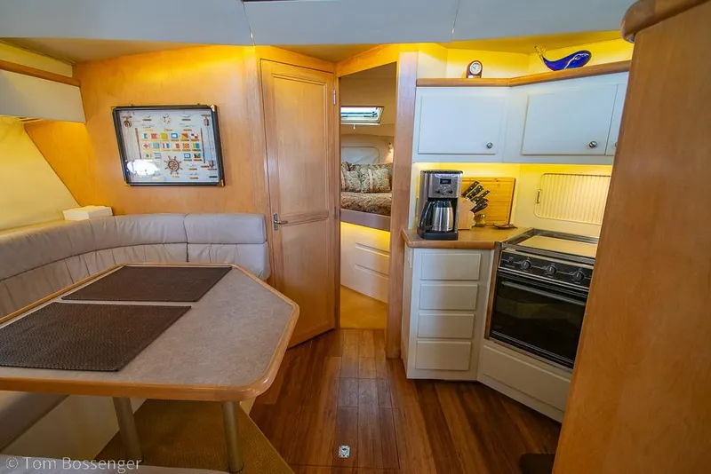 Slide: The Image of Interior of 1996 Carver 370 Aft Cabin Motor Yacht with cozy dining and kitchen area. - 16