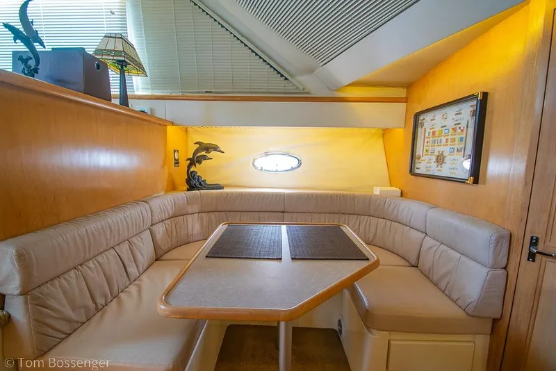 Slide: The Image of Interior of 1996 Carver 370 Aft Cabin Motor Yacht with cozy dining area. - 17