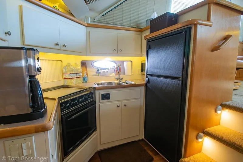 Slide: The Image of Compact kitchen in 1996 Carver 370 Aft Cabin Motor Yacht with appliances and storage. - 19