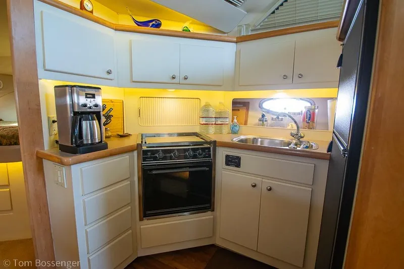Slide: The Image of Compact kitchen in a 1996 Carver 370 Aft Cabin Motor Yacht with modern appliances. - 20