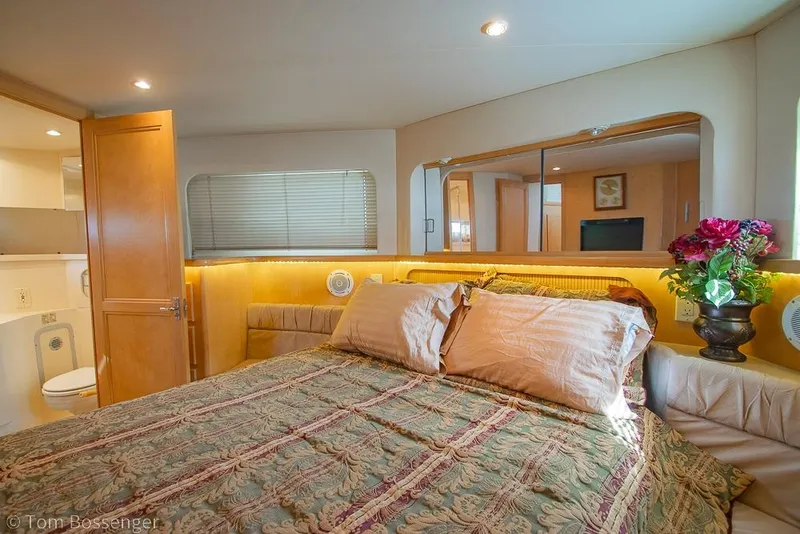 Slide: The Image of Luxurious bedroom interior of 1996 Carver 370 Aft Cabin Motor Yacht with elegant decor. - 24