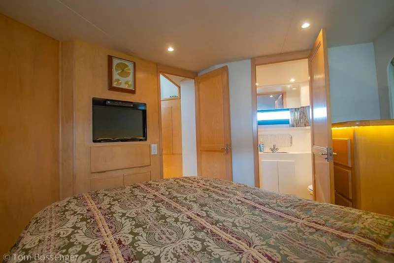 Slide: The Image of Interior of 1996 Carver 370 Aft Cabin Motor Yacht bedroom with ensuite bathroom. - 25