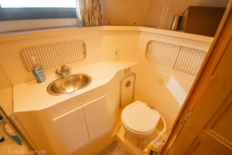 Slide: The Image of 1996 Carver 370 Aft Cabin Motor Yacht bathroom with sink and toilet. - 27