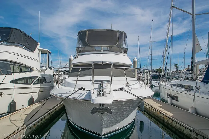 Slide: The Image of 1996 Carver 370 Aft Cabin Motor Yacht docked at marina under blue sky. - 3