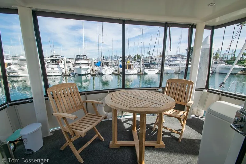Slide: The Image of 1996 Carver 370 Aft Cabin Motor Yacht with wooden chairs and table on deck. - 33