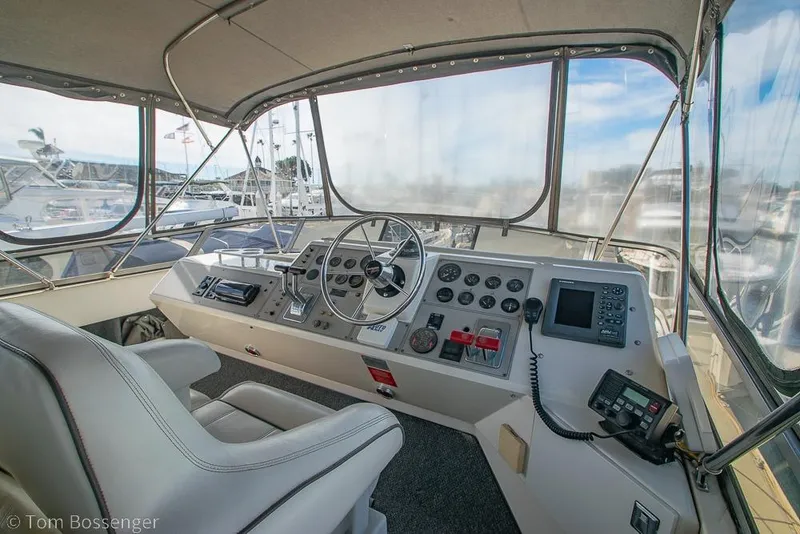 Slide: The Image of Interior helm of 1996 Carver 370 Aft Cabin Motor Yacht with steering wheel and controls. - 38