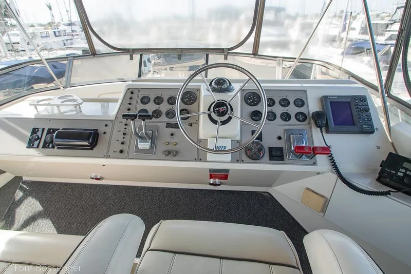 Slide: The Image of Helm of 1996 Carver 370 Aft Cabin Motor Yacht with steering wheel and navigation controls. - 39
