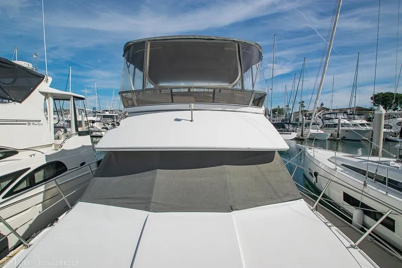 Slide: The Image of 1996 Carver 370 Aft Cabin Motor Yacht docked at marina under clear blue sky. - 45