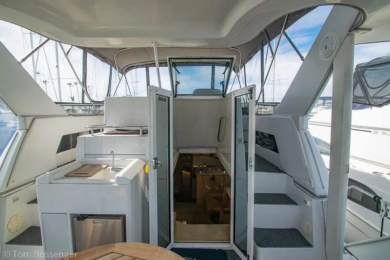 Slide: The Image of 1996 Carver 370 Aft Cabin Motor Yacht interior with kitchenette and stairs. - 5