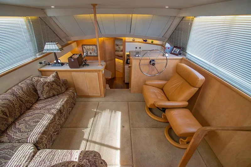 Slide: The Image of Interior of 1996 Carver 370 Aft Cabin Motor Yacht with plush seating and helm. - 6