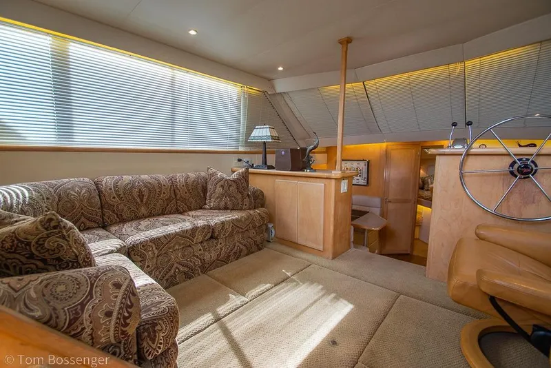 Slide: The Image of Luxurious interior of 1996 Carver 370 Aft Cabin Motor Yacht with plush seating and helm. - 7