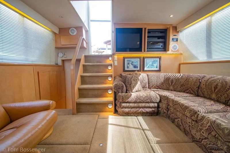 Slide: The Image of Luxurious interior of 1996 Carver 370 Aft Cabin Motor Yacht with plush seating and entertainment area. - 9