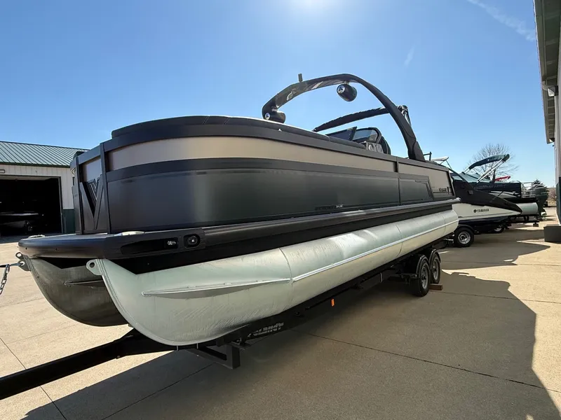Slide: The Image of 2024 Viaggio Diamante pontoon boat on trailer under sunny sky. - 2