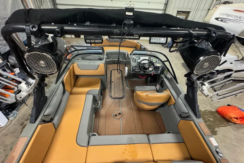 Slide: The Image of 2020 Heyday WT-2DC boat interior with tan seating and advanced audio system. - 13