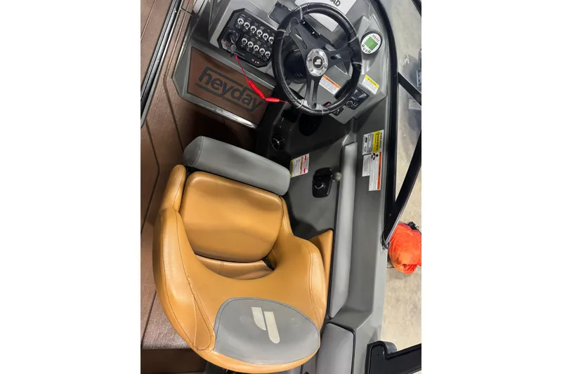 Slide: The Image of 2020 Heyday WT-2DC boat cockpit with steering wheel and tan seat. - 5