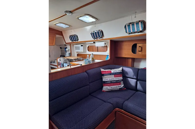Slide: The Image of Interior of 1998 Caliber 40LRC yacht with cozy seating and nautical decor. - 11
