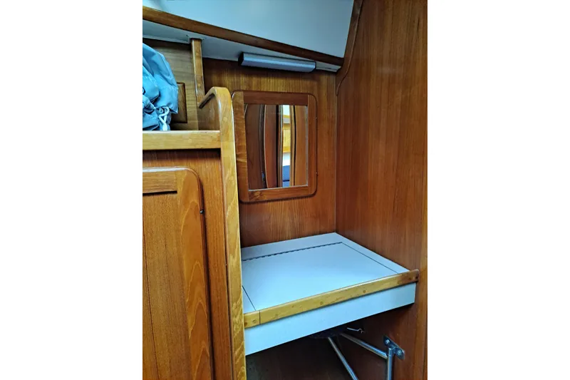Slide: The Image of Wooden interior of 1998 Caliber 40LRC sailboat with mirror and storage space. - 13