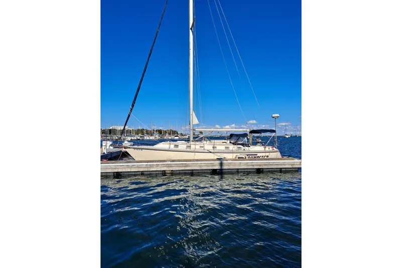 Slide: The Image of Sailboat Caliber 40LRC 1998 docked in marina under clear blue sky. - 2