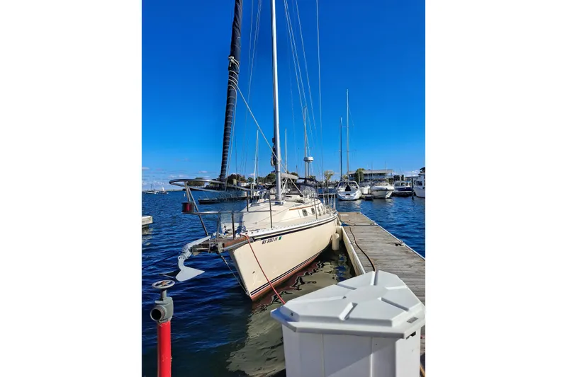 Slide: The Image of Sailboat docked at marina, 1998 Caliber 40LRC, under clear blue sky. - 4