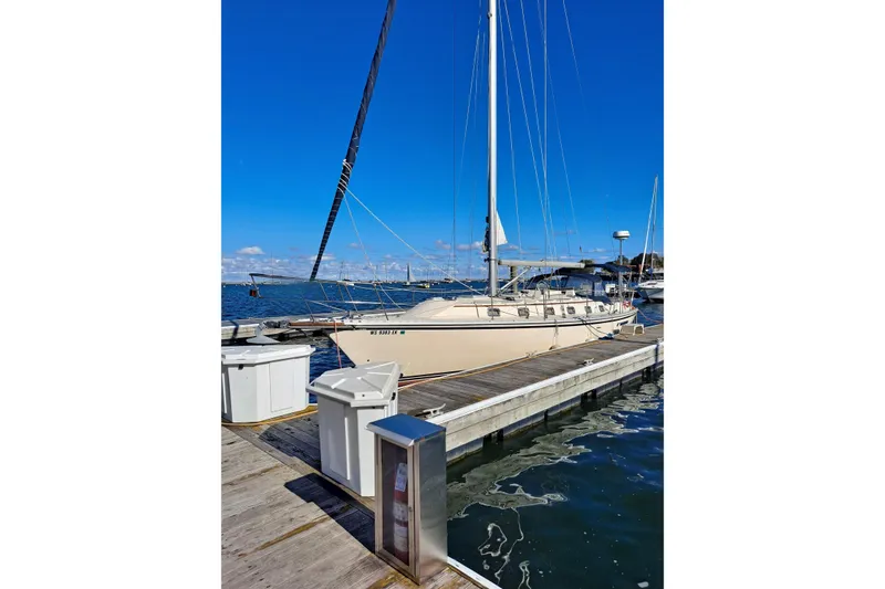 Slide: The Image of 1998 Caliber 40LRC sailboat docked on a sunny day. - 5