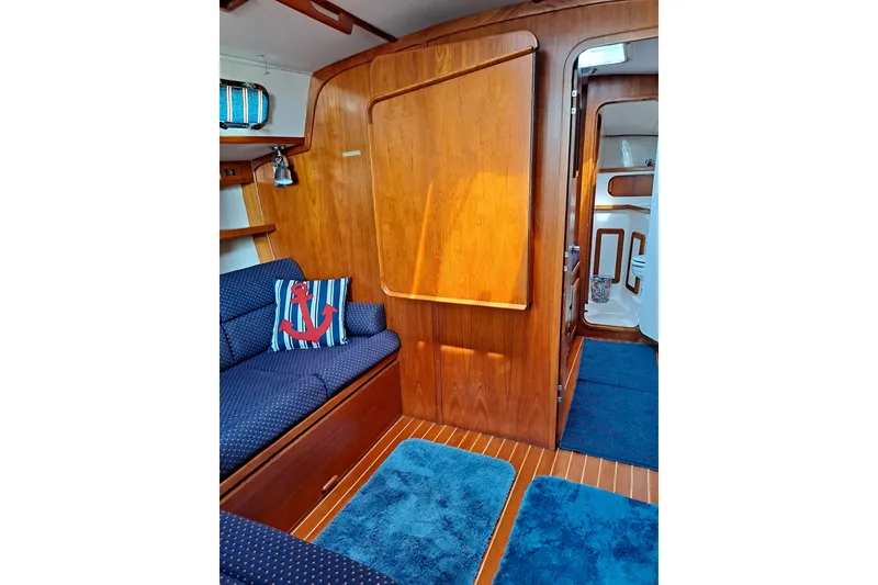 Slide: The Image of Interior of 1998 Caliber 40LRC yacht with wooden paneling and nautical-themed decor. - 7