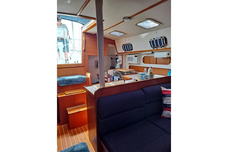 Slide: The Image of Interior of 1998 Caliber 40LRC sailboat with cozy seating and kitchen area. - 8