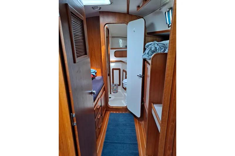 Slide: The Image of Interior of 1998 Caliber 40LRC sailboat with wooden cabinetry and compact bathroom. - 9