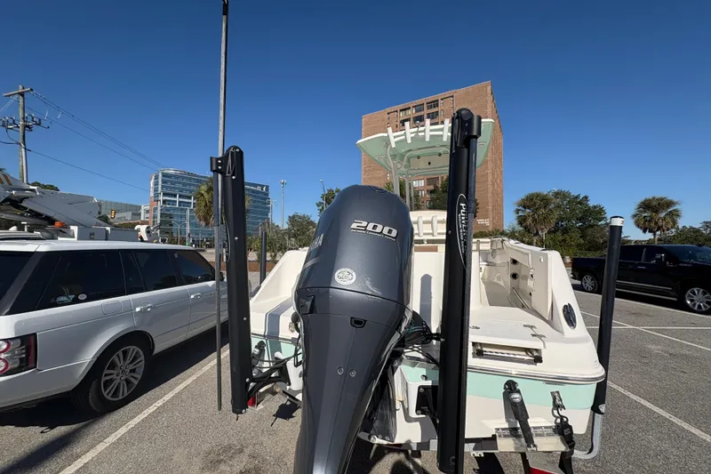 Slide: The Image of 2017 Robalo R222 boat with Yamaha 200 engine in a parking lot. - 16