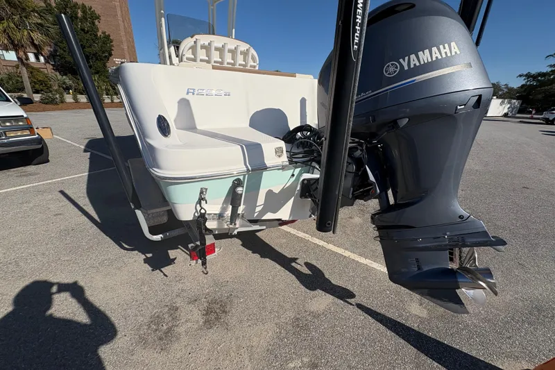 Slide: The Image of 2017 Robalo R222 boat with Yamaha outboard motor in a parking lot. - 18