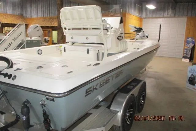 The Image of 2025 Skeeter SX241 boat displayed indoors on a trailer. - 1