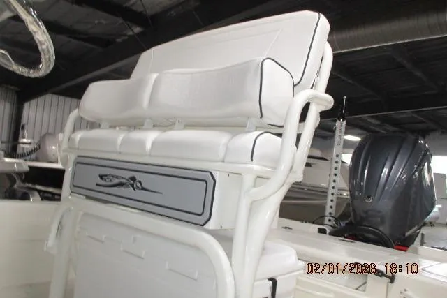 Slide: The Image of 2025 Skeeter SX241 boat with white seating and motor in a showroom. - 3