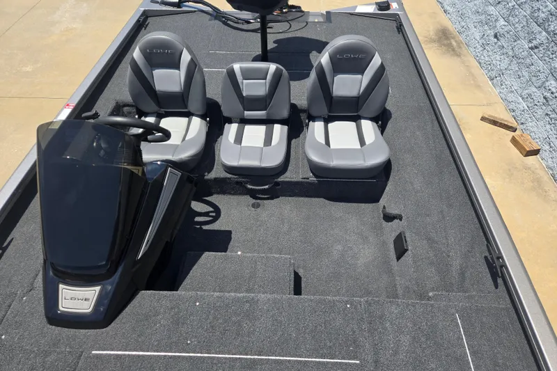 Slide: The Image of 2026 Lowe Stinger 195C boat interior with three gray seats and steering console. - 8